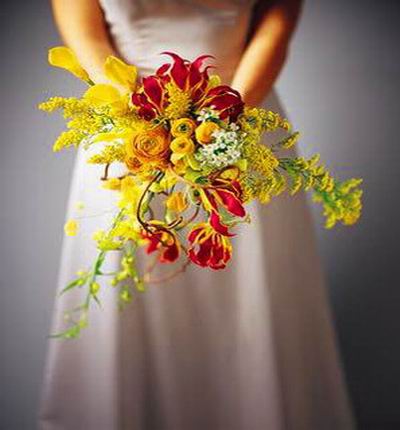 Fiery Lilies, yellow Callas and yellow Roses mix display