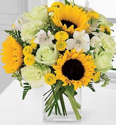 3 Sunflowers, 4 white Roses, 3 white pistachio Carnations, 5 Alstomerias and yellow button poms.