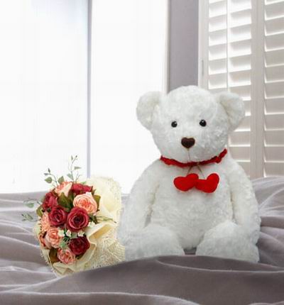 6 red and 6 pink Roses and greenery with a 20cm Teddy bear.  Teddy bears may vary based on availability.