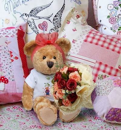 6 red and 6 pink Roses and greenery with a 20cm Teddy bear.  Teddy bears may vary based on availability.